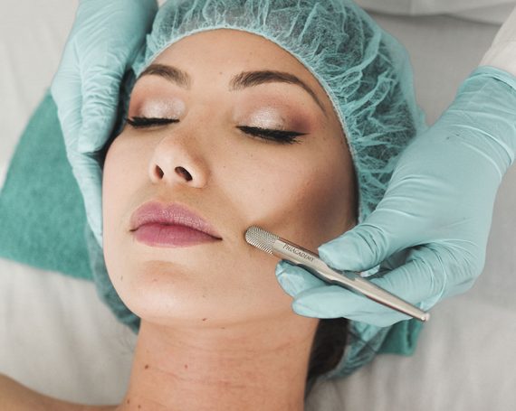 Woman receiving a cosmetic facial treatment at a clinic.